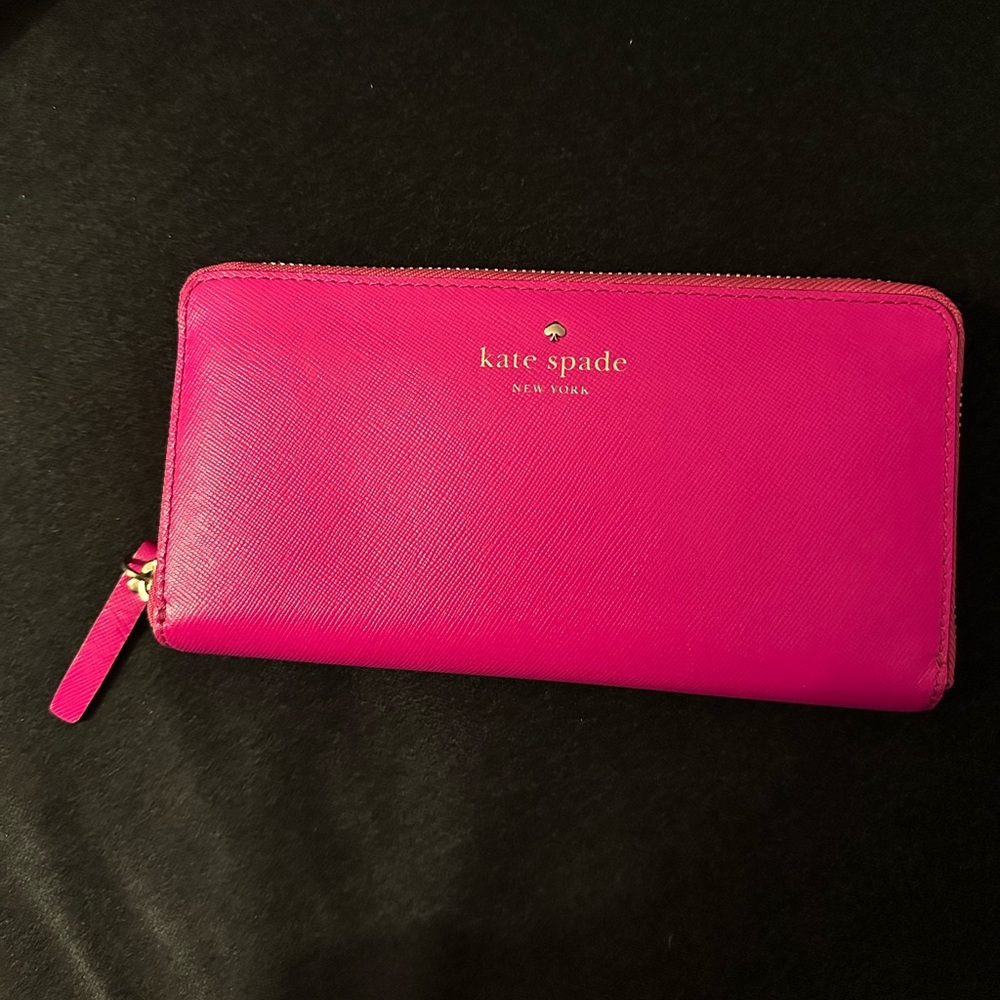 Hot pink Kate Spade wallet with gold zipper and polka dotted interior
